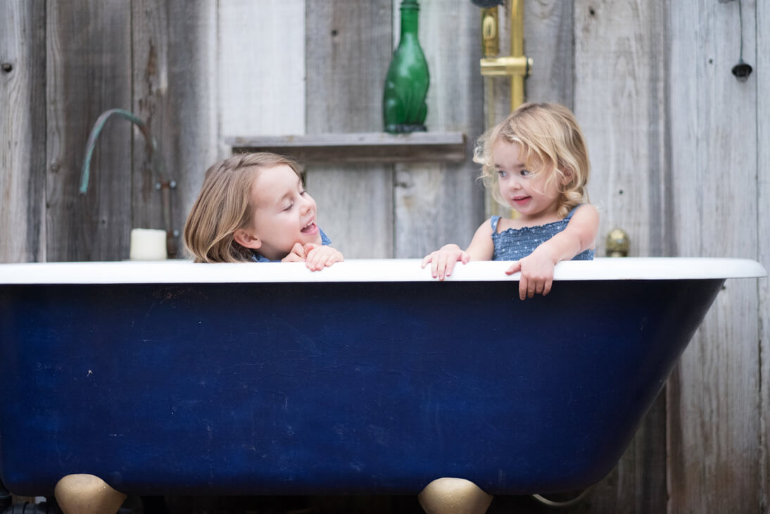 Family photo of sisters in an outdoor bath tub