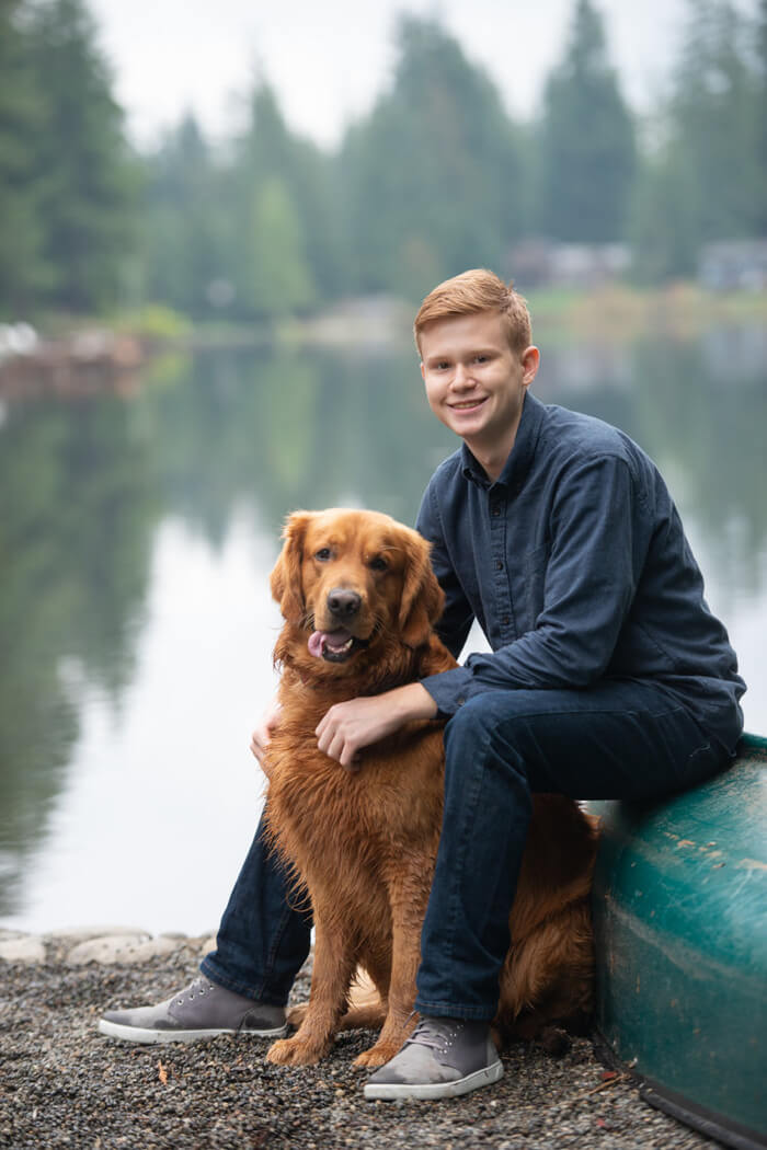 A portrait of a yound man with his dog