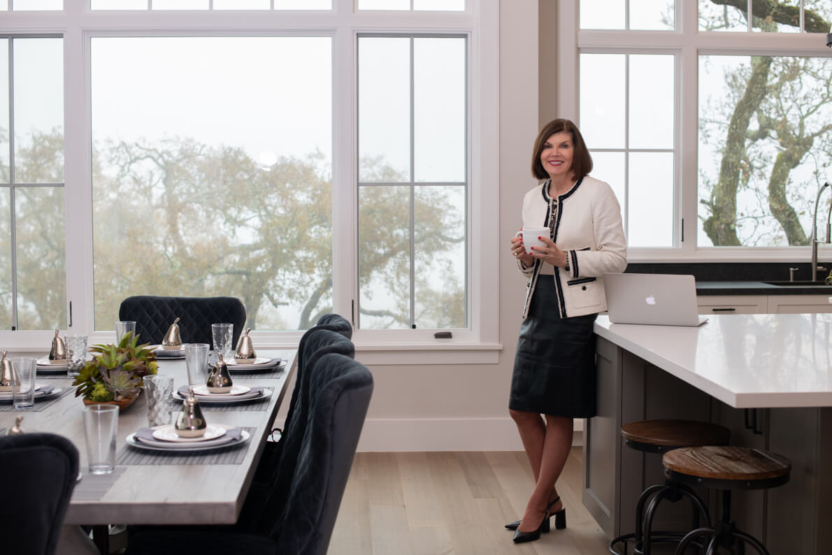 Real estate agent poses in luxury home